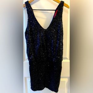 Woman’s stunning black sequence dress from AKIRA Chicago Red Label. Size medium.
